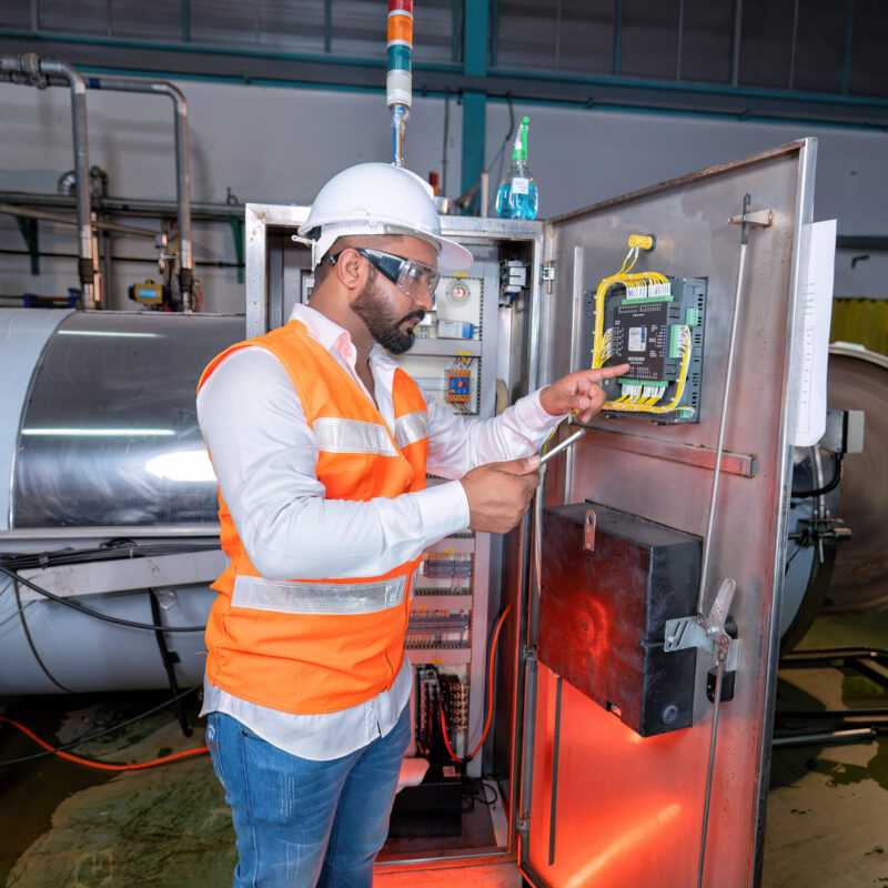 Electrical engineer inspection control panel and commissioning during pressure steam drum shutdown